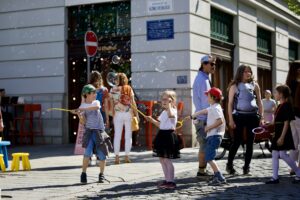 Children play on the street during the Start with Children summit